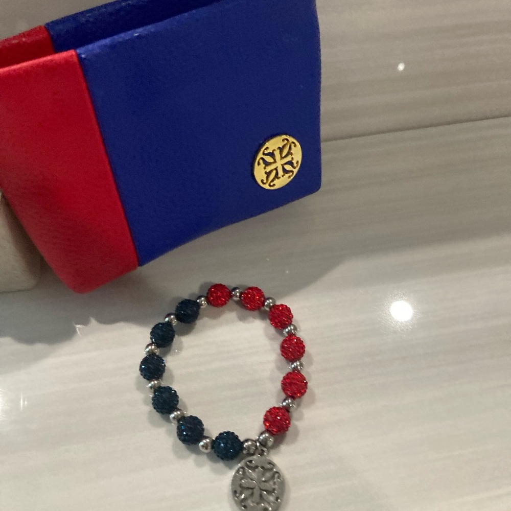 brand new red and blue beaded bracelet with charm and matching reusable bag